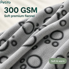 Close-up texture view of the 300 GSM soft premium flannel material featuring a grey paw-print pattern.