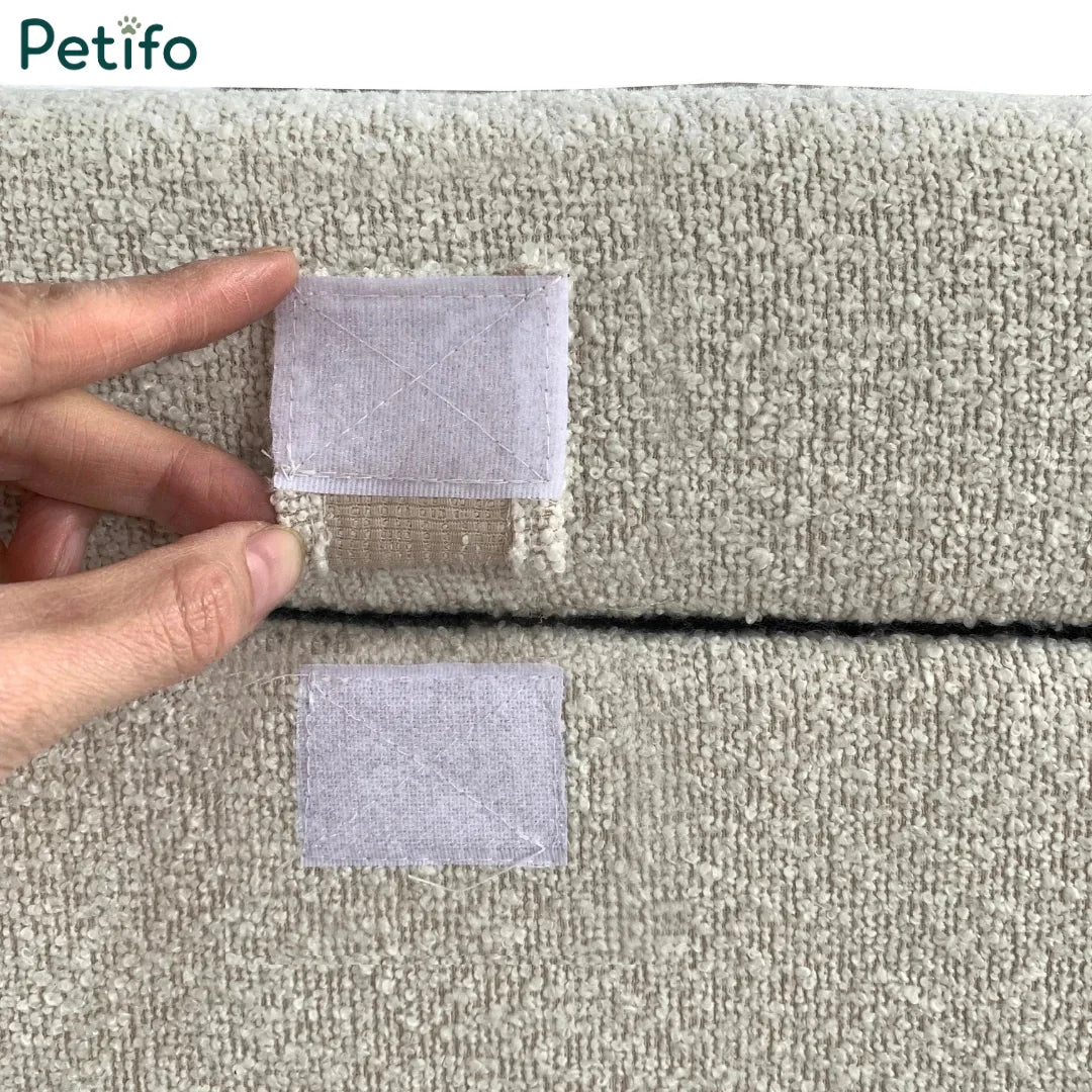  A close-up view of the hook-and-loop velcro attachment tab securing the folded pouffe configuration.