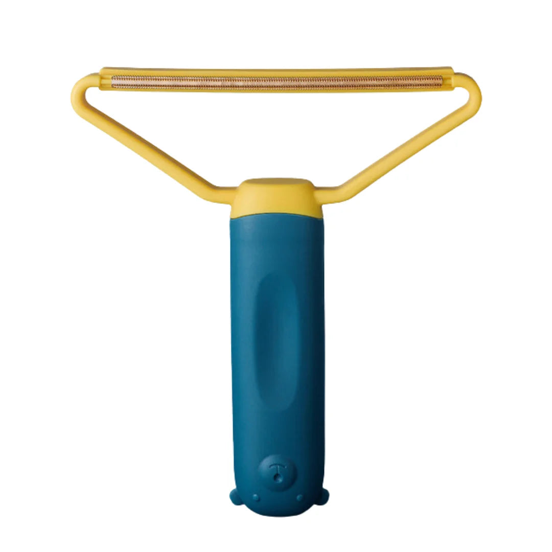 Dark blue and yellow lint remover tool featuring a triangular scraping head and bear-shaped handle base.