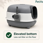 Side view of the grey and white covered litter box highlighting its elevated bottom and attached hanging scoop.