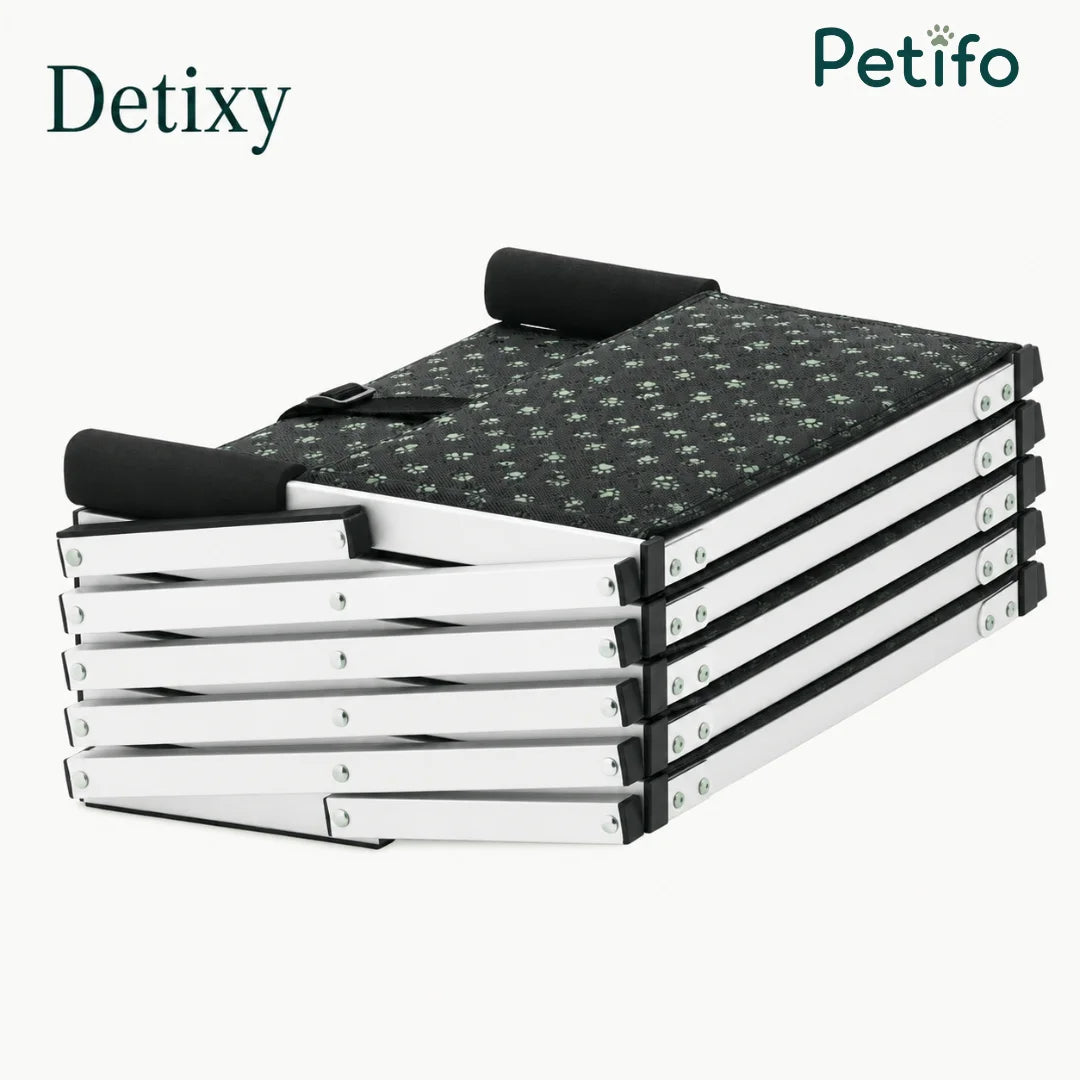 Detixy branded portable dog stairs folded down into a compact, flat position for easy storage.