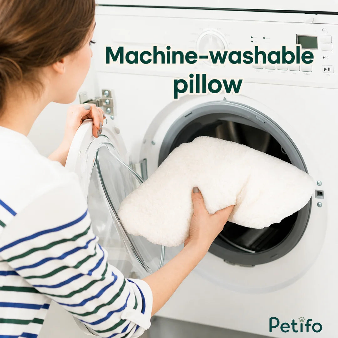 A person placing a soft white plush pet bed cushion into a washing machine for easy cleaning.
