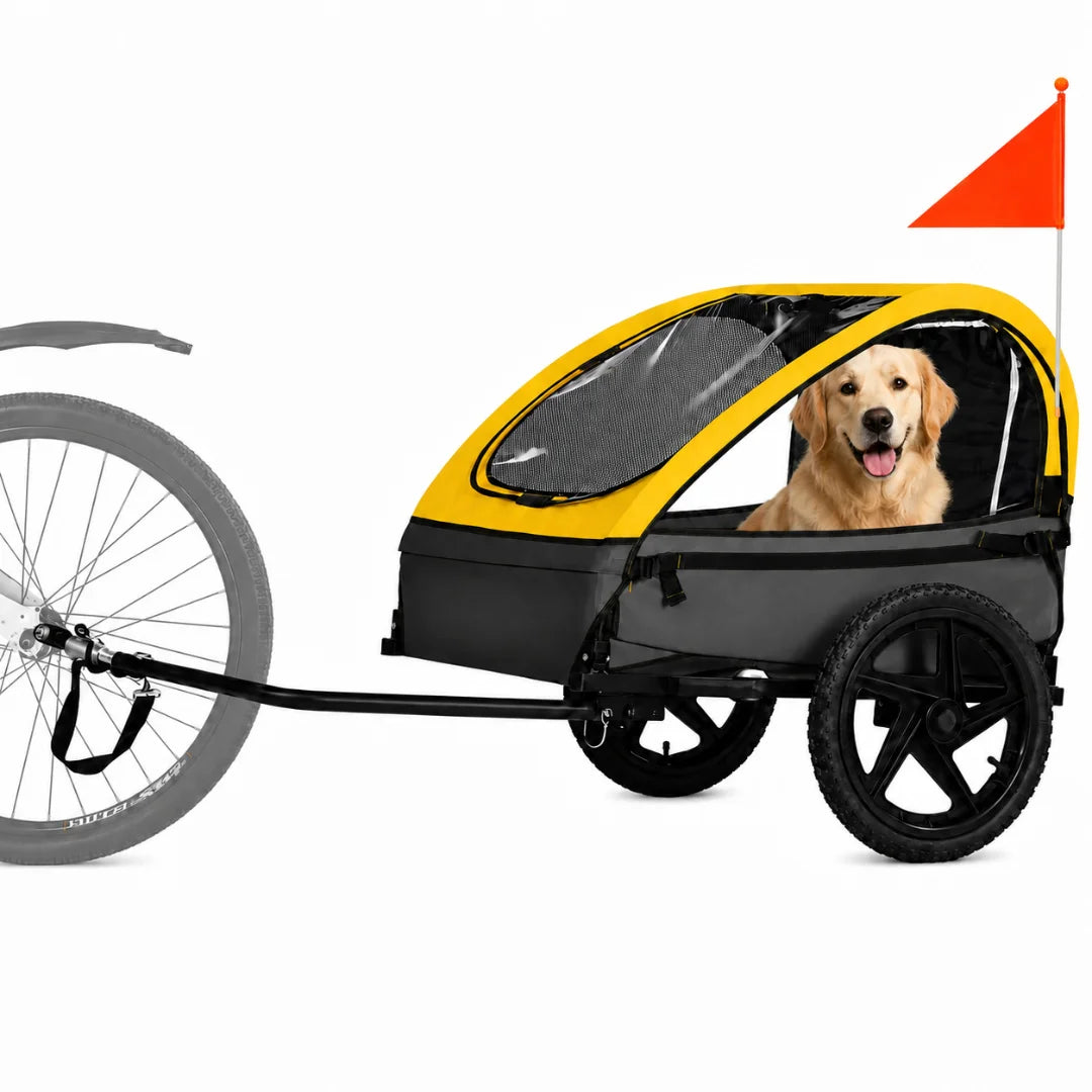A yellow and grey pet bike trailer with a safety flag, featuring a happy golden retriever inside.